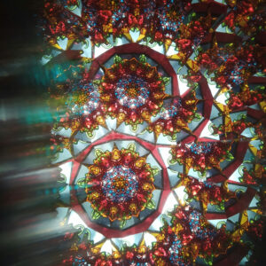 Collard Spiritual Direction photo of a kaleidoscope in jewel tones with some light streaming in/blurring. Photo by Marina Zorg via Unsplash.