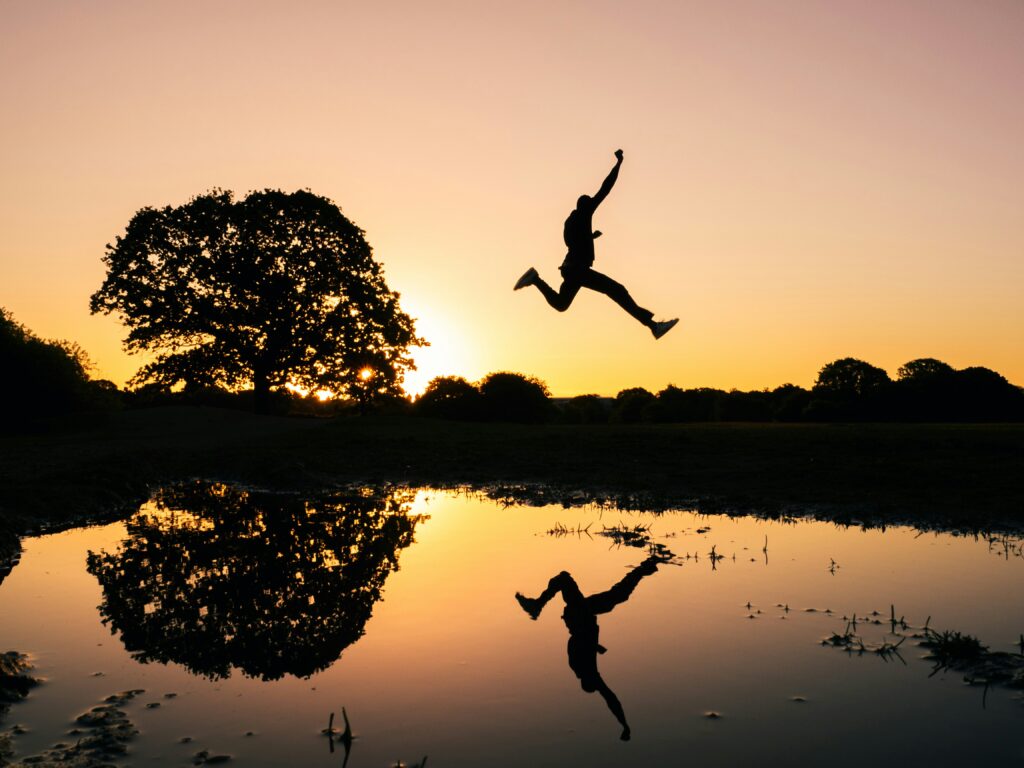 Collard Spiritual Direction - Seeing with our Souls - Image of person leaping over water at sunrise/set by Kid Circus via Unsplash