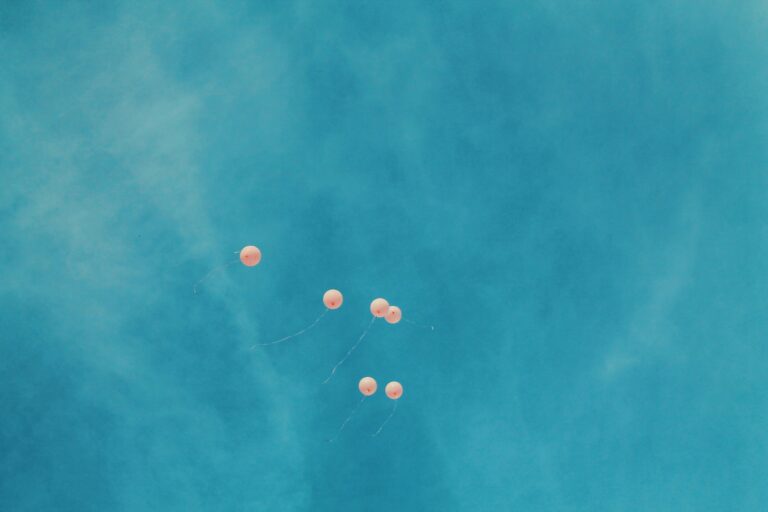 Collard Spiritual Direction - Winter Solstice - peach helium balloons floating across a bright blue sky by Bri Tucker via Unsplash